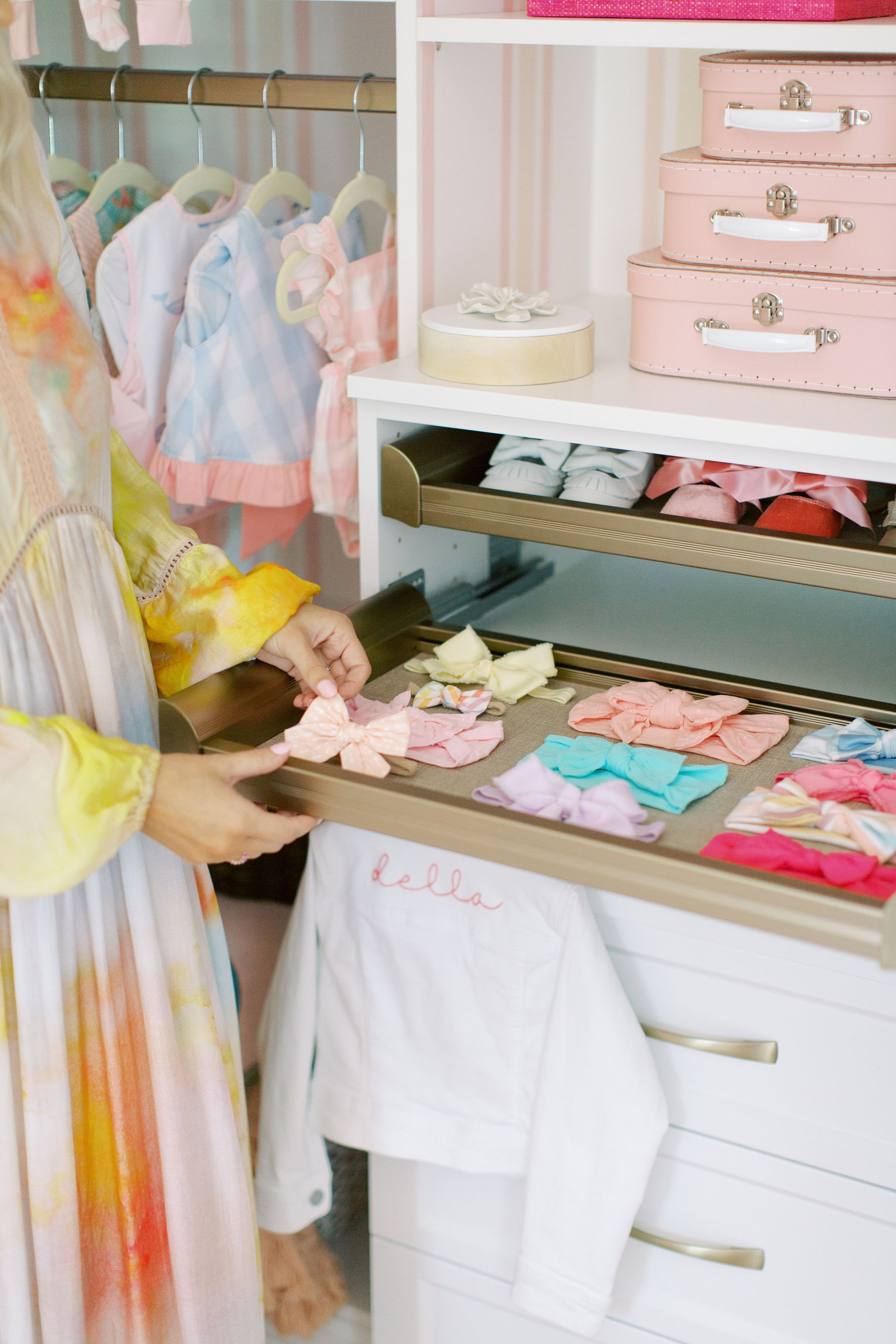 Pastel baby closet with clothing and bows